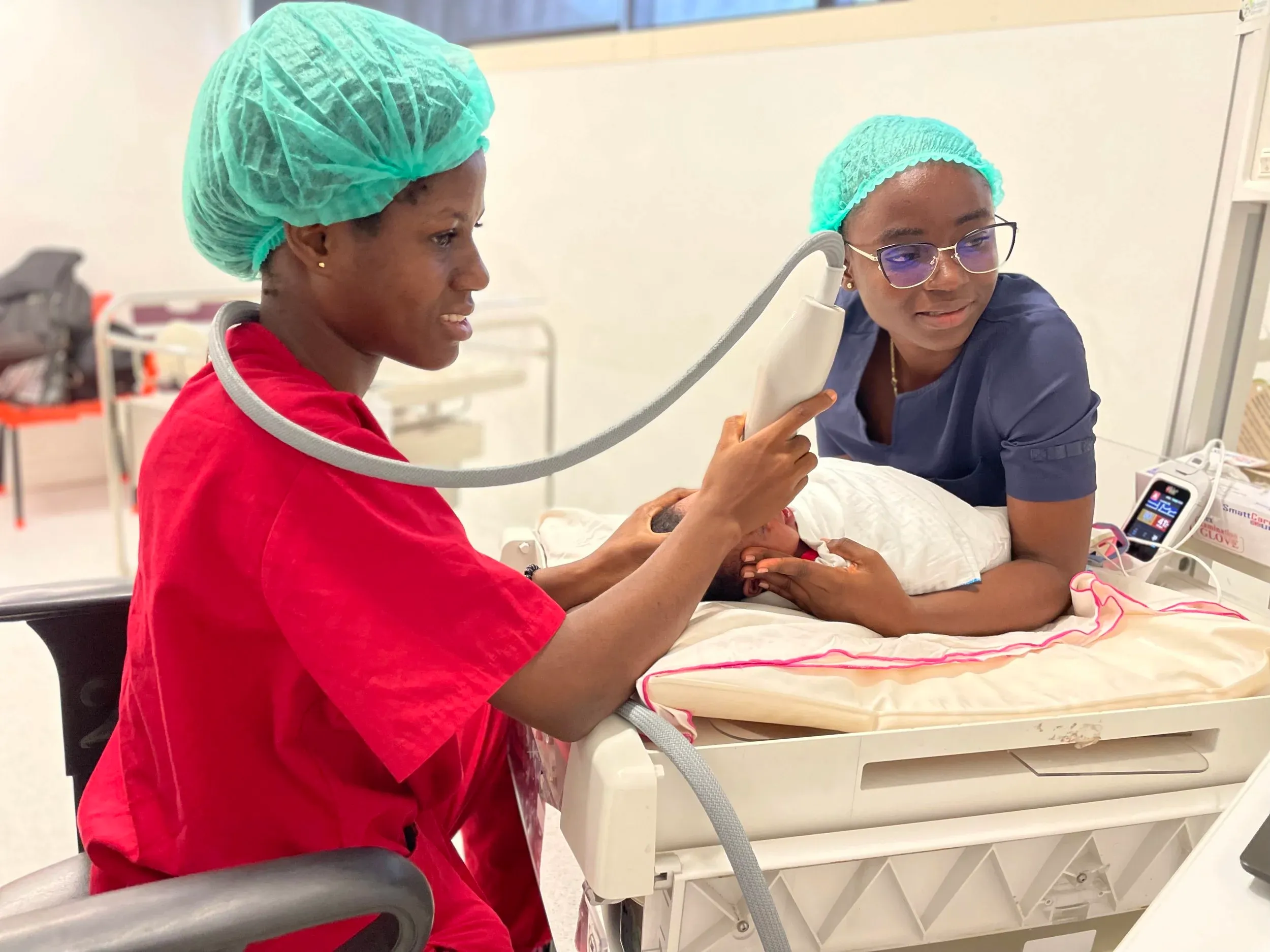 ROP clinicians examining a baby
